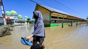 Indonesia flood survivors battle mud, trauma