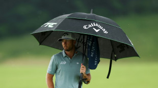 Burns leads Scott by one as dangerous weather halts US Open